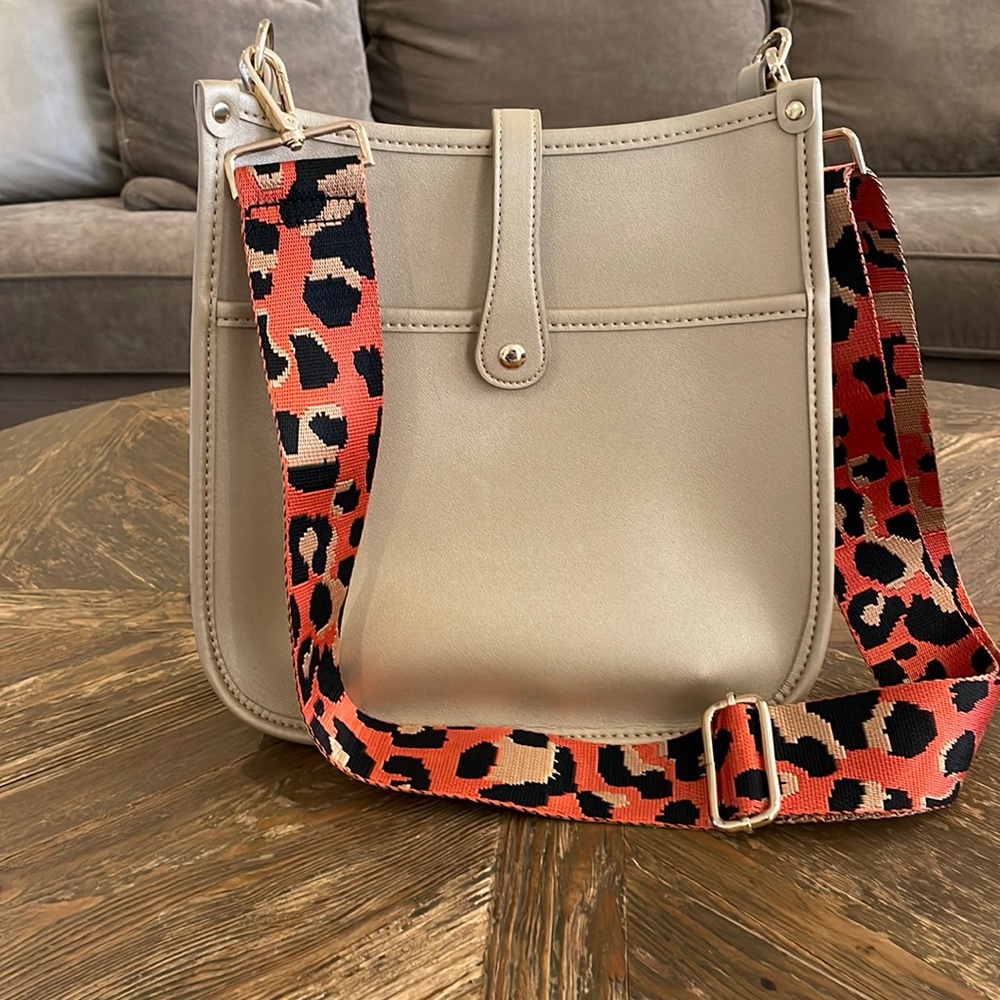 Gold crossbody bag with orange leopard strap